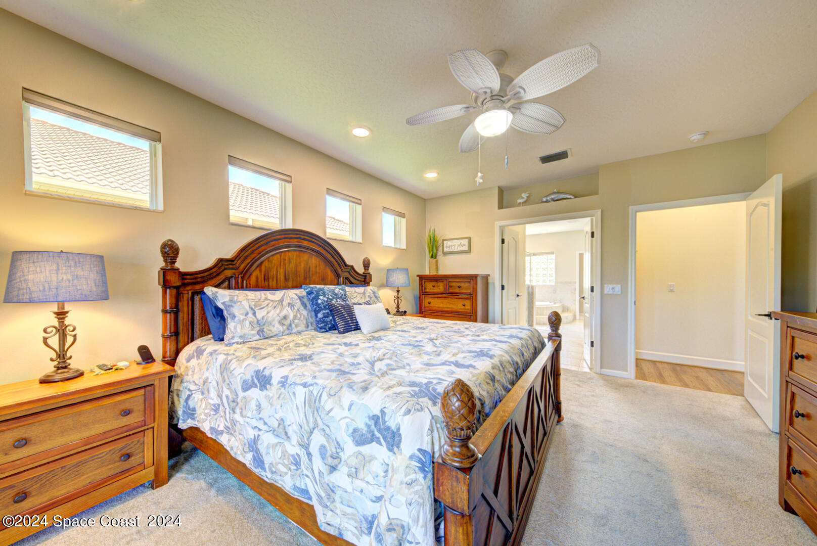 4070 Stoney Point Road Melbourne, FL 32940 - Photo 35 of 75 a bedroom with a bed and a dresser with mirror