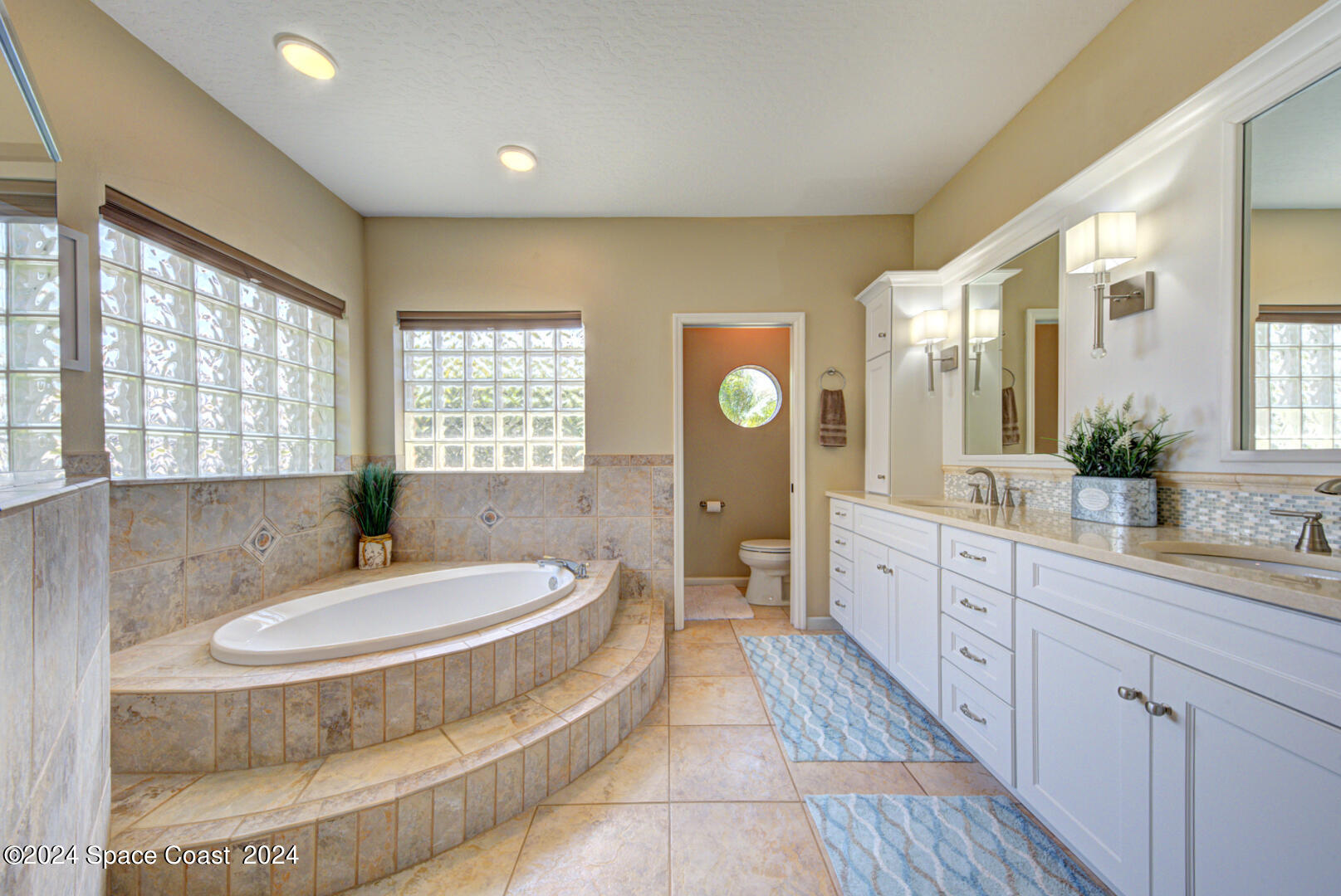 4070 Stoney Point Road Melbourne, FL 32940 - Photo 43 of 75 a spacious bathroom with a tub sink and mirror