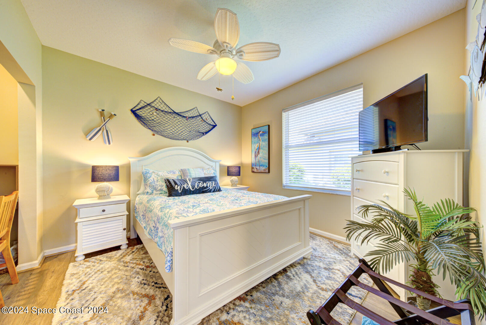 4070 Stoney Point Road Melbourne, FL 32940 - Photo 47 of 75 a bed room with a bed window and a flat screen tv