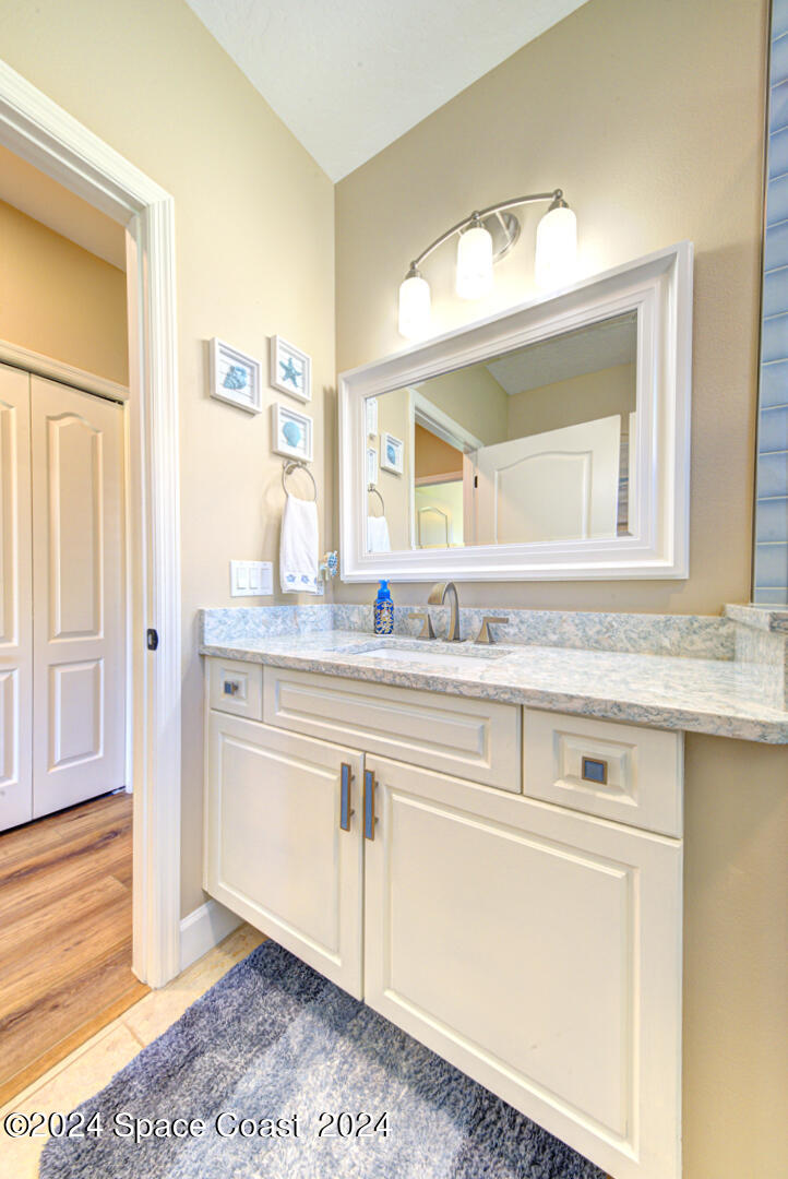 4070 Stoney Point Road Melbourne, FL 32940 - Photo 49 of 75 a bathroom with a sink and a mirror