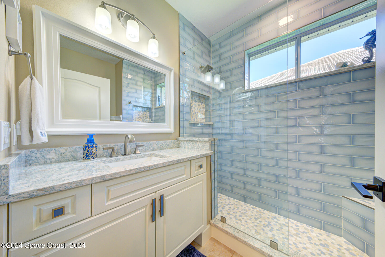 4070 Stoney Point Road Melbourne, FL 32940 - Photo 50 of 75 a bathroom with a granite countertop sink a vanity and a mirror
