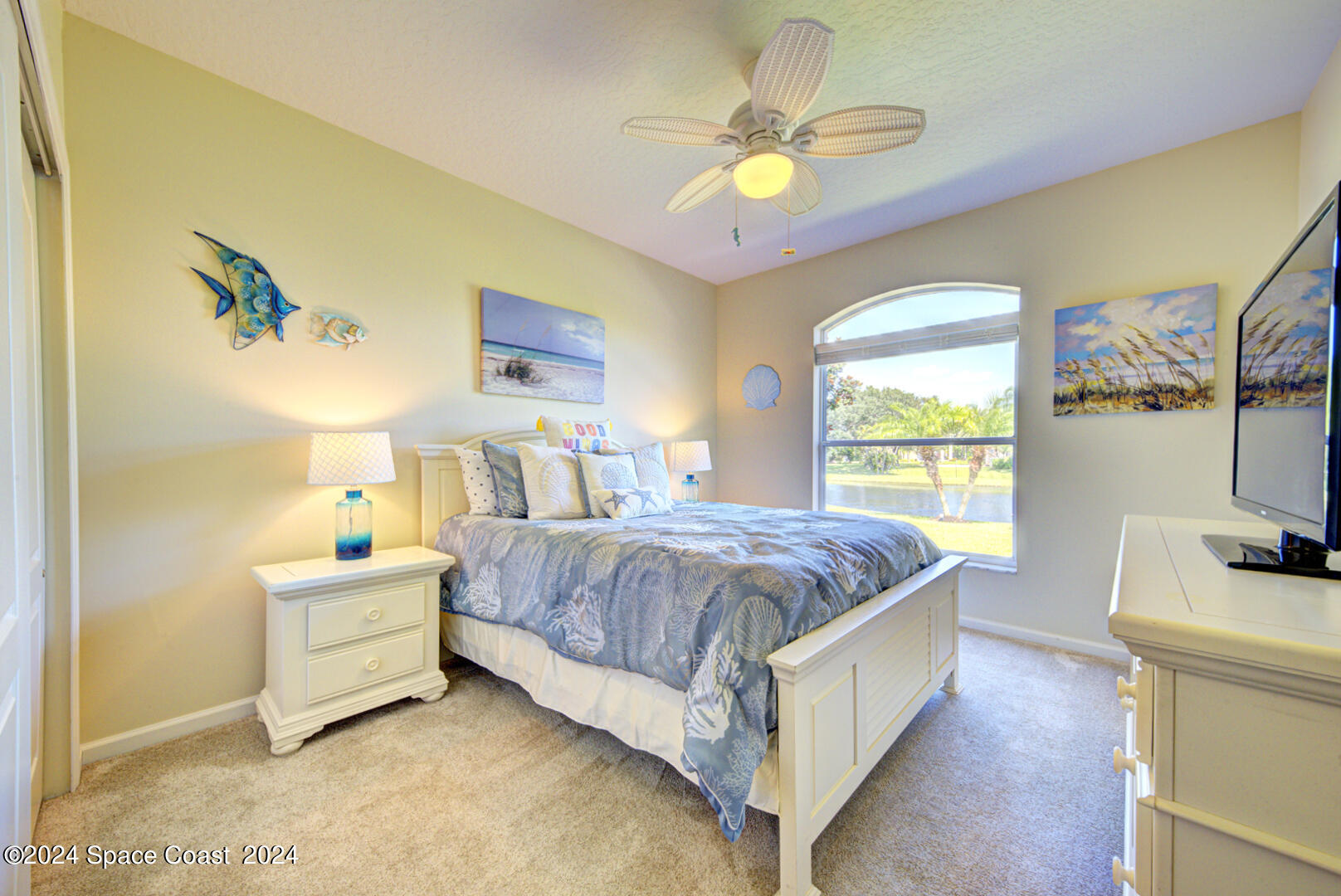 4070 Stoney Point Road Melbourne, FL 32940 - Photo 52 of 75 a bedroom with a bed and a flat screen tv