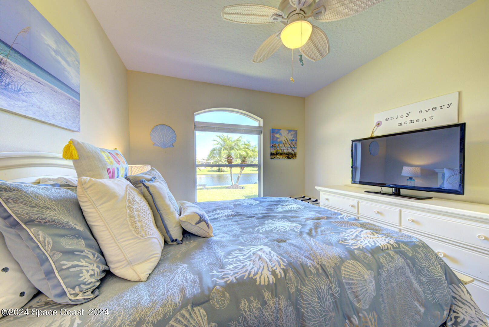 4070 Stoney Point Road Melbourne, FL 32940 - Photo 53 of 75 a bedroom with a bed and a flat screen tv