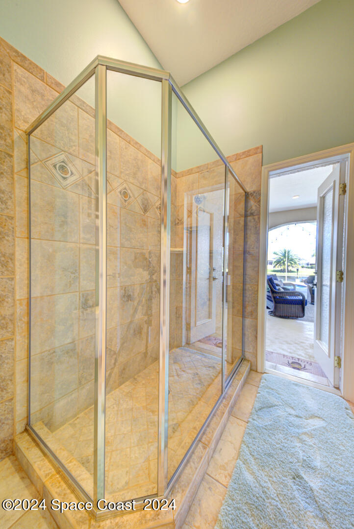 4070 Stoney Point Road Melbourne, FL 32940 - Photo 56 of 75 a bathroom with a glass shower door