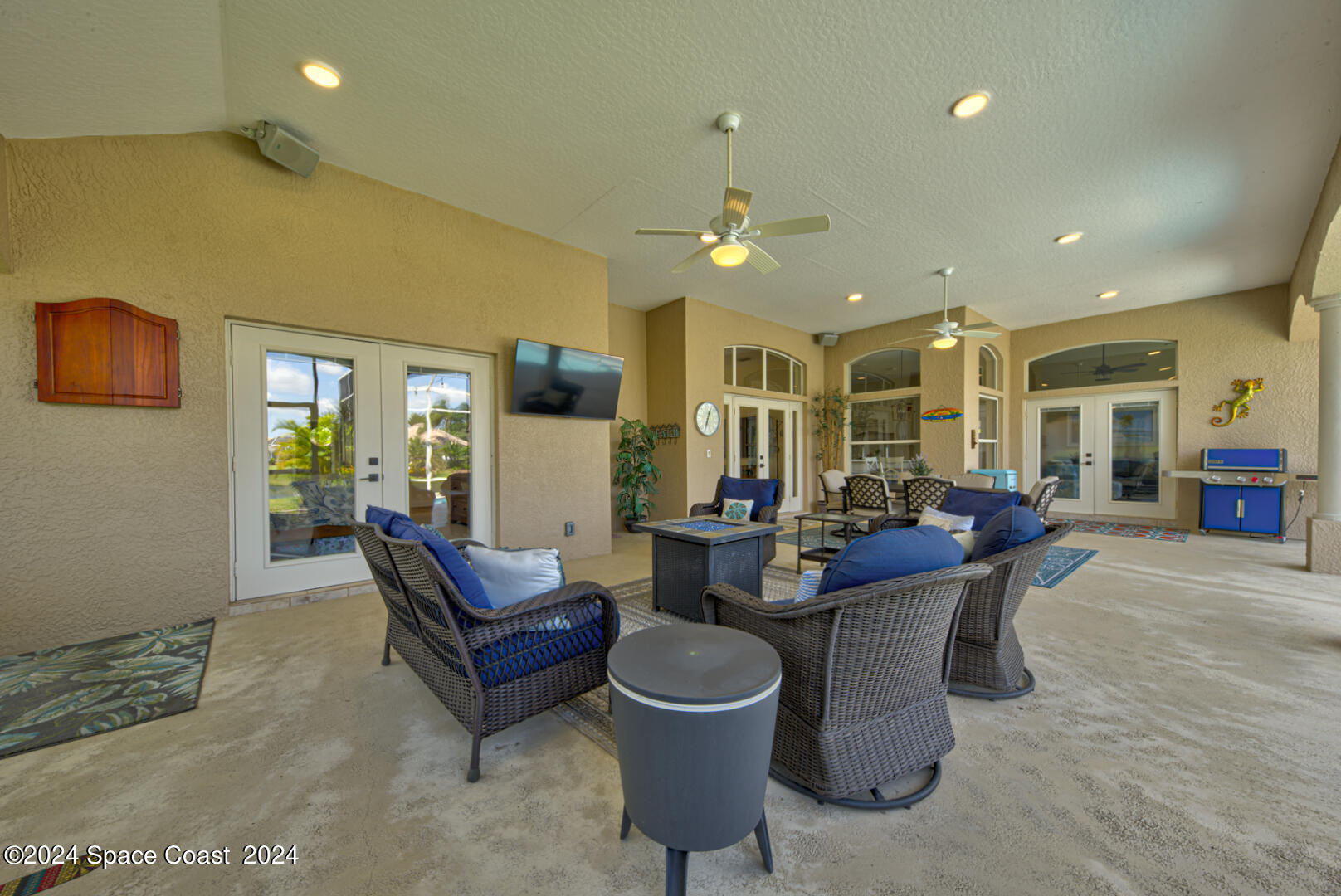 4070 Stoney Point Road Melbourne, FL 32940 - Photo 58 of 75 a living room with furniture a chandelier and a dining table