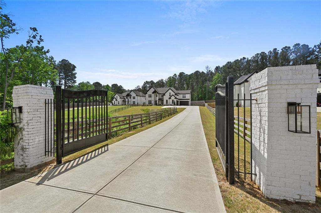 2694 Thompson Mill Road Buford, GA 30519 - Photo 2 of 70 a view of a pathway with a wrought fence