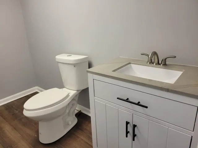 a white toilet sitting next to a bathroom sink
