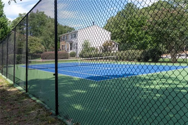 a view of a yard with wooden fence