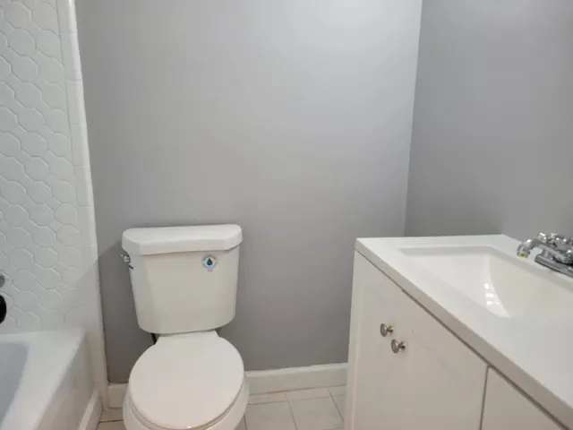 a white toilet sitting next to a white sink