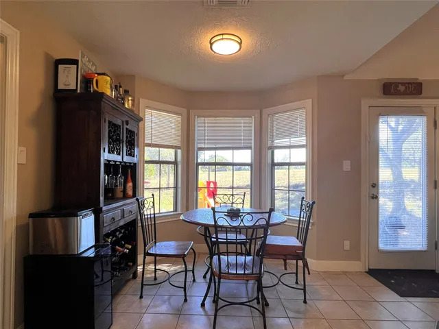 a view of a dining room with furniture and a window