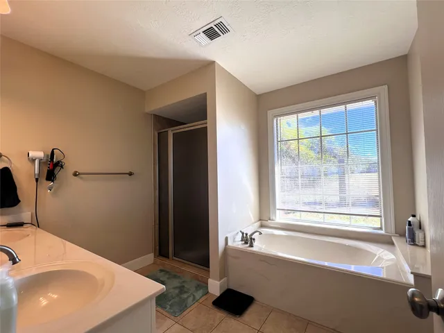 a bathroom with a bathtub and a sink