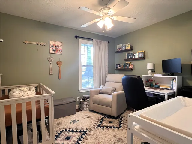 a bedroom with furniture and a window