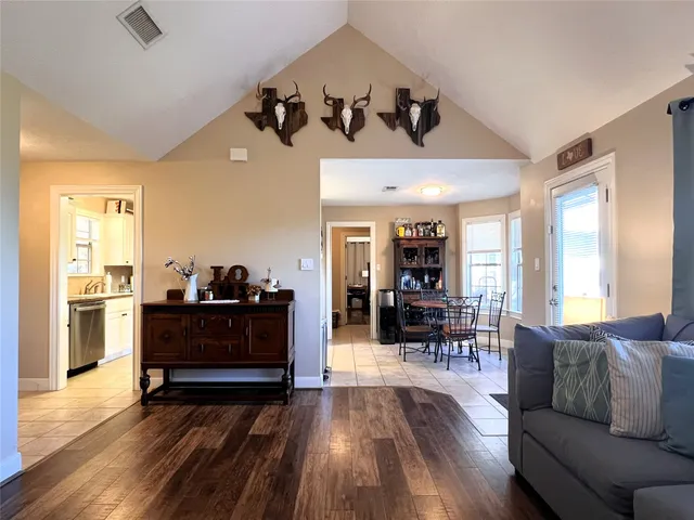 a living room with furniture and wooden floor