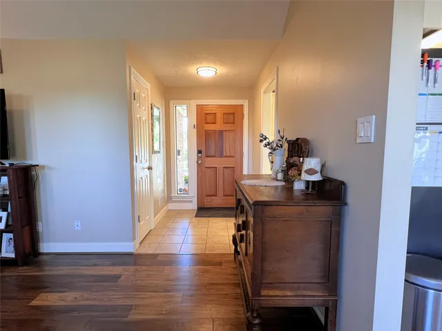 a view of a workspace with furniture and wooden floor