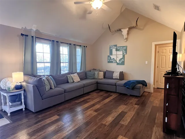 a living room with furniture and a flat screen tv