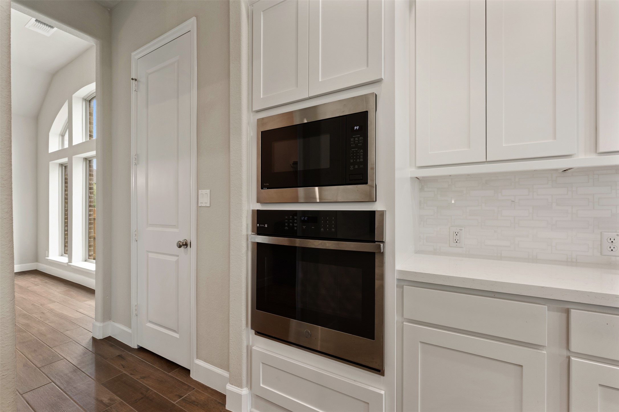 104 Anejo Bluff Georgetown, TX 78628 - Photo 25 of 40 a kitchen with stainless steel appliances white cabinets and a stove