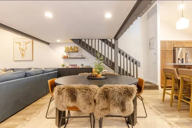 a kitchen with a sink a cabinets and chairs
