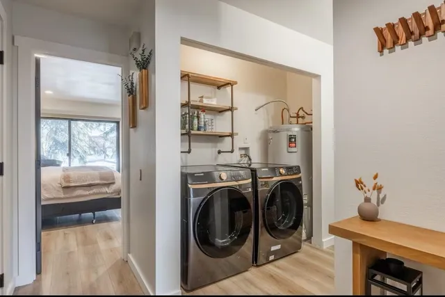 a living room with a baby crib furniture and a window