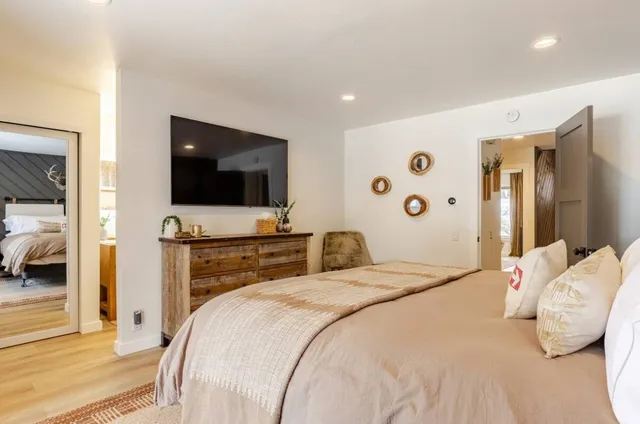 a bedroom with a bed and wooden floor