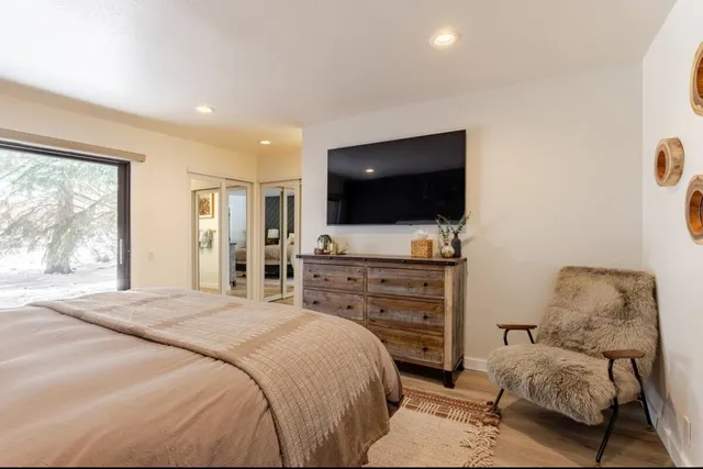 a bedroom with a bed and a flat screen tv