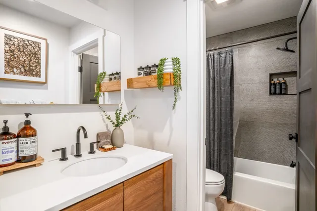 a bathroom with a sink toilet and shower