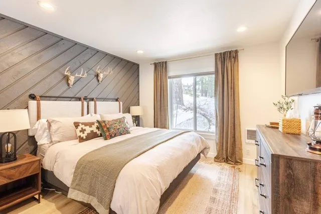 a bed sitting in a bedroom next to a window