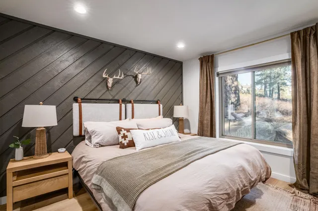 a bedroom with a large bed and a large window