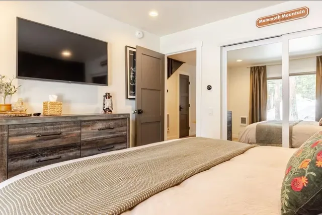 a bedroom with a large bed and a lamp on table