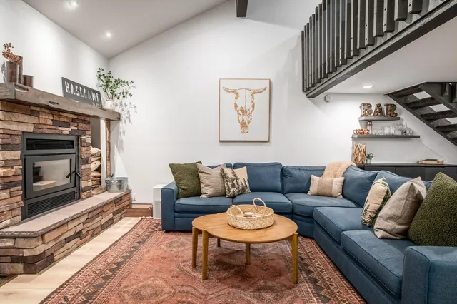 a living room with furniture a fireplace and a flat screen tv
