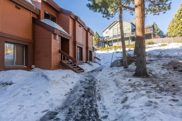 a living room filled with furniture and a large window