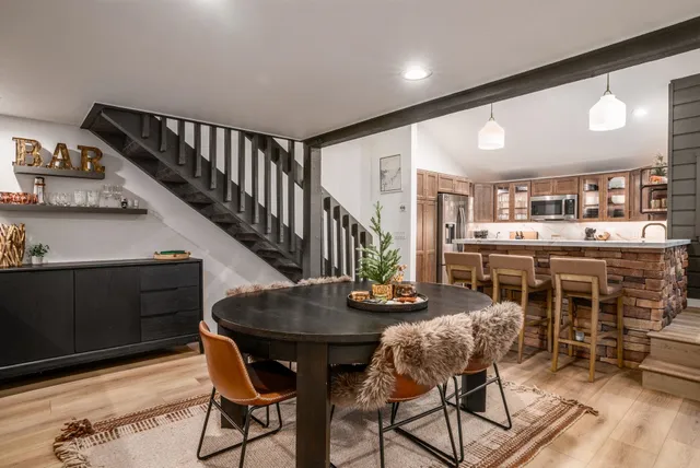 a dining room with furniture and wooden floor