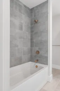a bathroom with a bathtub and a shower