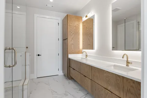 a bathroom with a double vanity sink mirror and