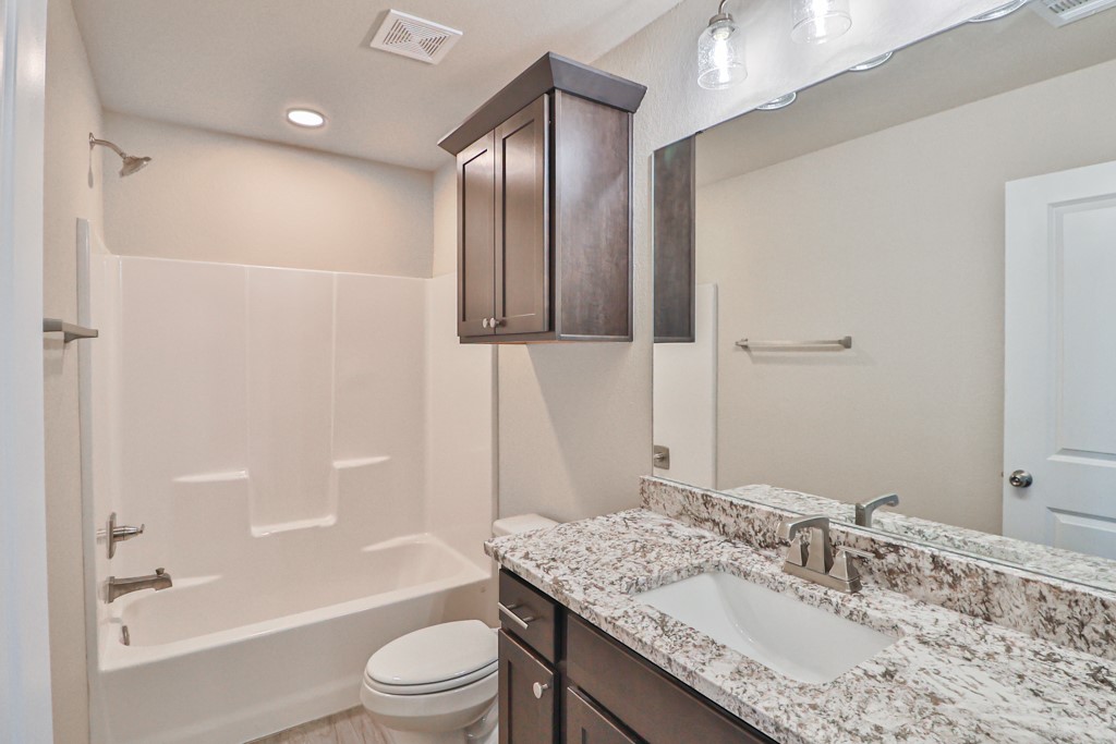 2871 Messenger Way Bryan, TX 77803 - Photo 10 of 13 a bathroom with a granite countertop sink toilet and shower