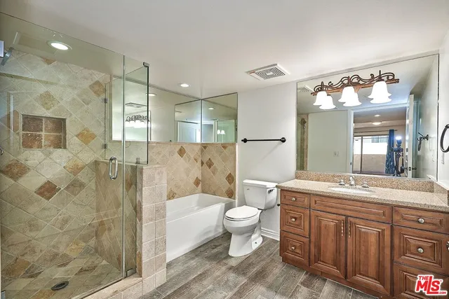 a bathroom with a bathtub shower sink and toilet