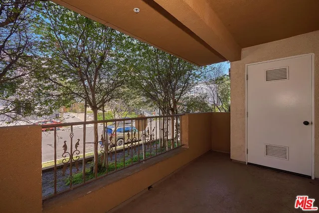 a view of a hallway with furniture