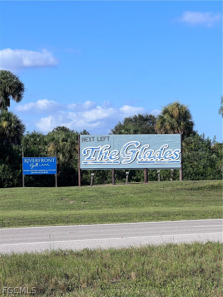 Northside Road Moore Haven, FL 33471 - Photo 5 of 8 a sign board with a play ground in the back