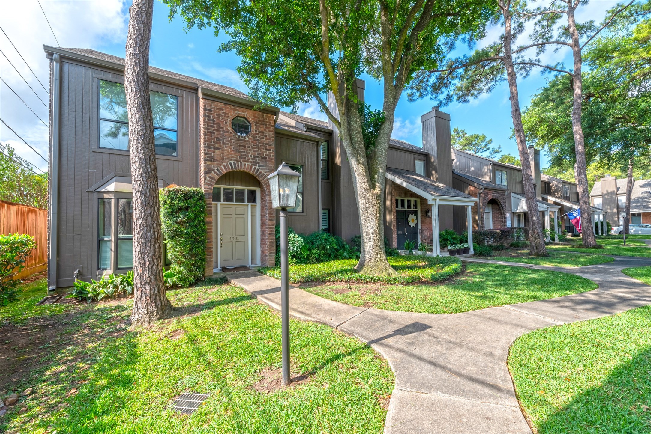701 Bering Drive, Unit 1901 Houston, TX 77057 - Photo 1 of 29 a front view of a house with garden