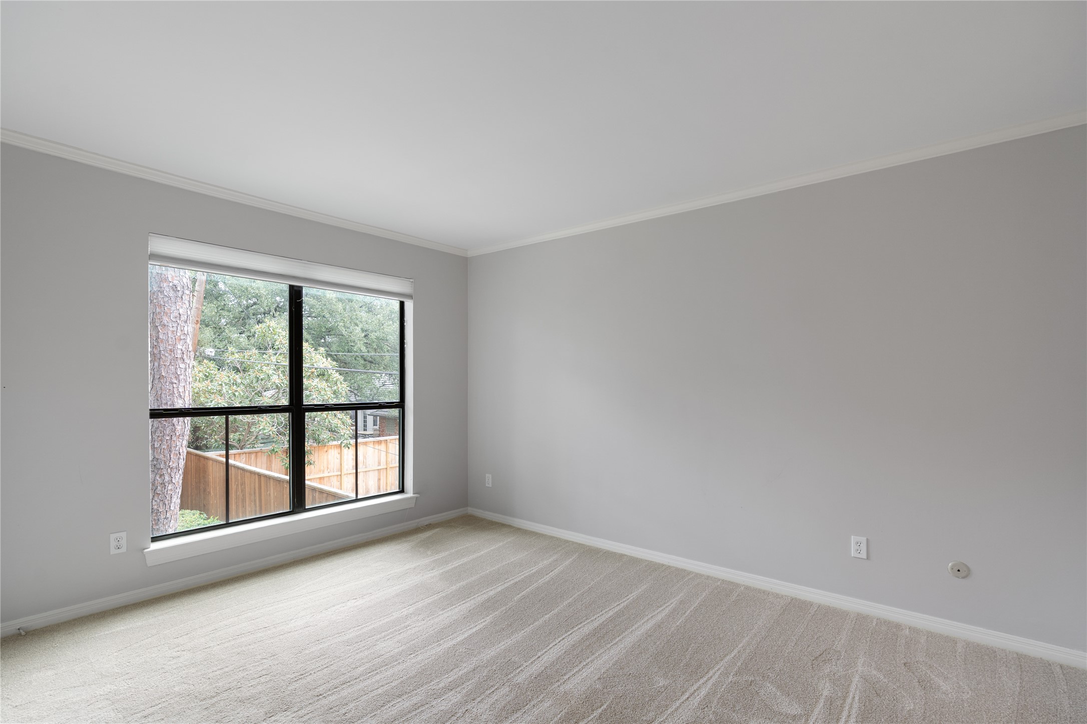 701 Bering Drive, Unit 1901 Houston, TX 77057 - Photo 13 of 29 an empty room with wooden floor and windows