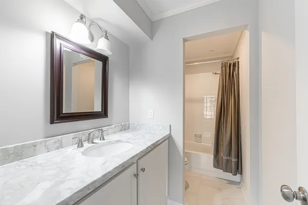 a bathroom with a granite countertop sink vanity and mirror