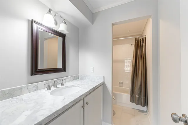 a bathroom with a granite countertop sink vanity and mirror
