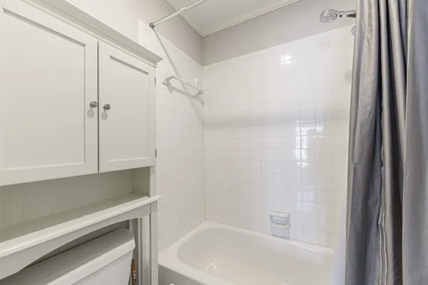 a bathroom with a bathtub and a shower