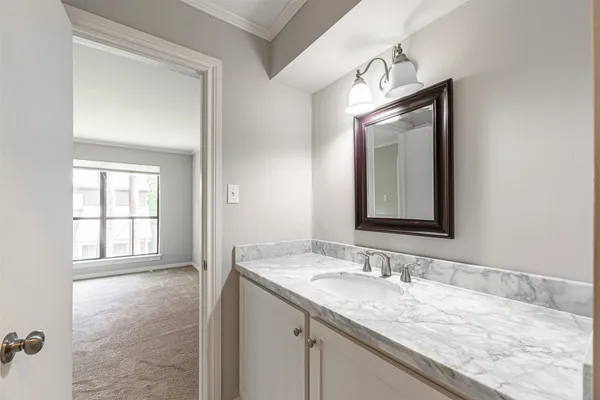 a bathroom with a granite countertop sink and a mirror