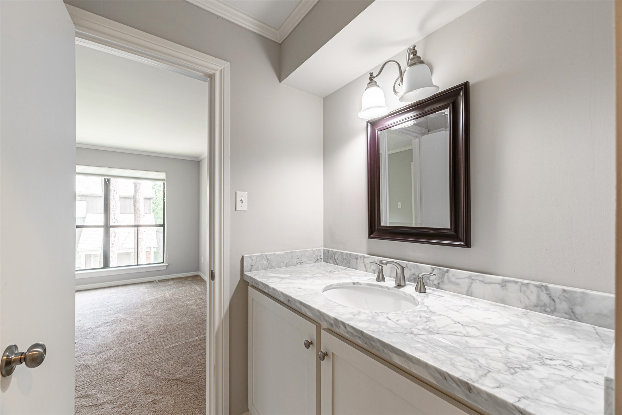 701 Bering Drive, Unit 1901 Houston, TX 77057 - Photo 18 of 29 a bathroom with a granite countertop sink and a mirror