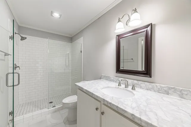 a bathroom with a granite countertop sink toilet and shower