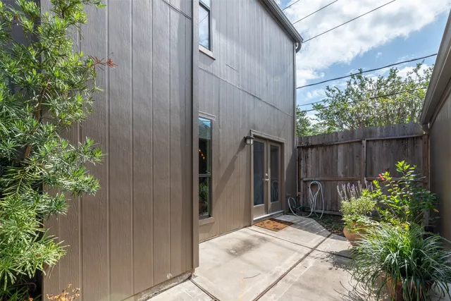a backyard of a house with plants and tree