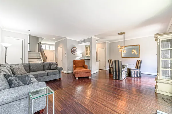 a living room with furniture and a wooden floor