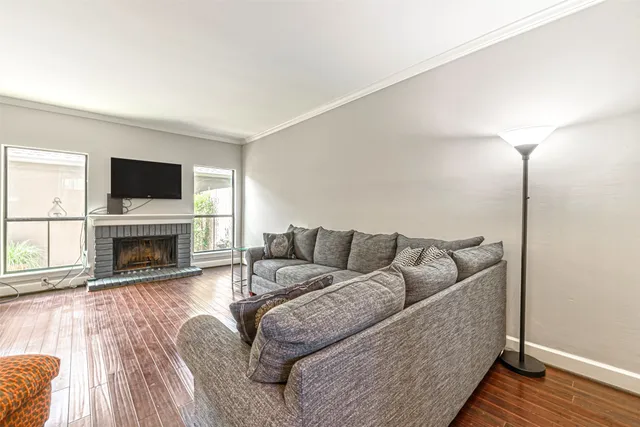 a living room with furniture a fireplace and a flat screen tv