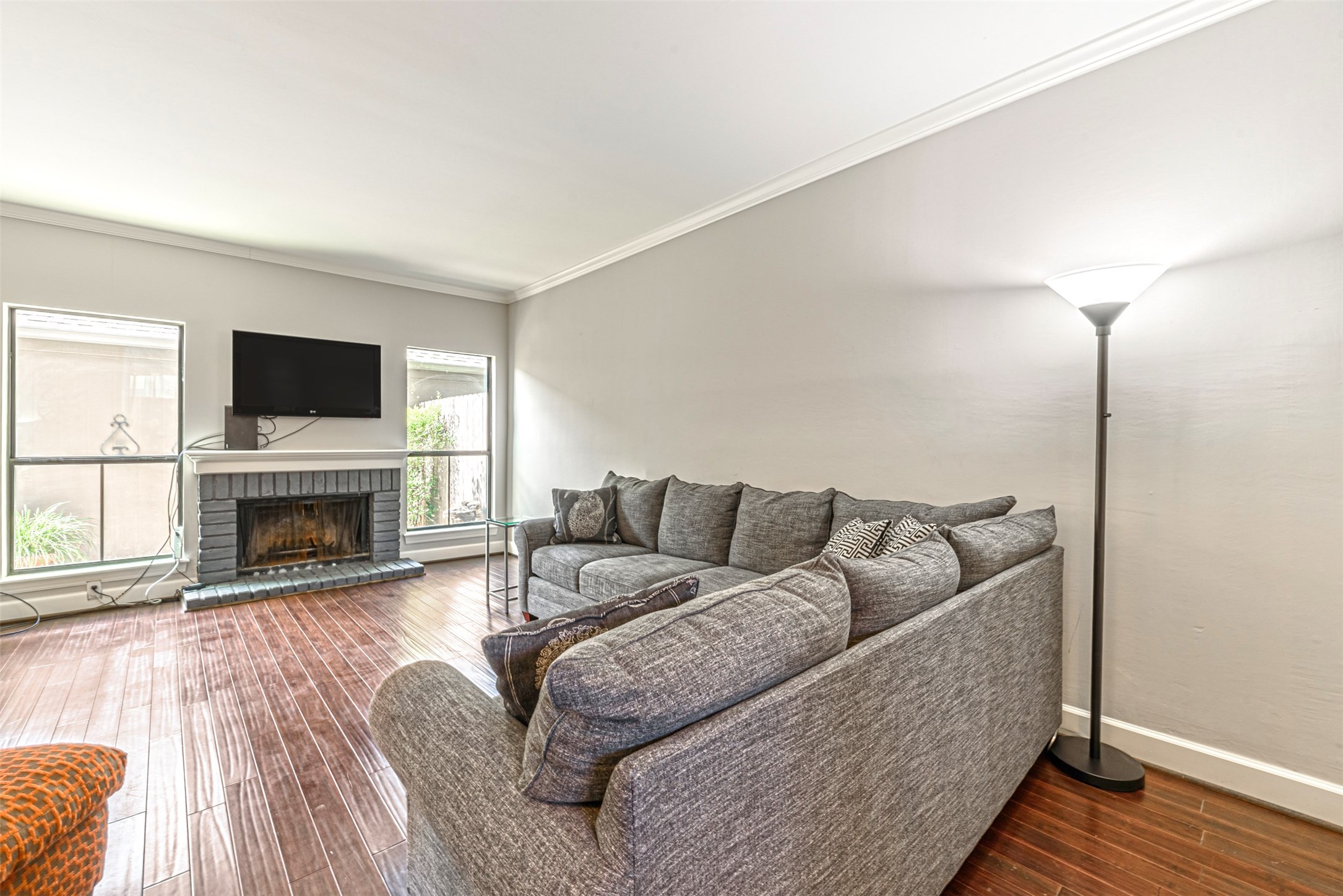 701 Bering Drive, Unit 1901 Houston, TX 77057 - Photo 7 of 29 a living room with furniture a fireplace and a flat screen tv