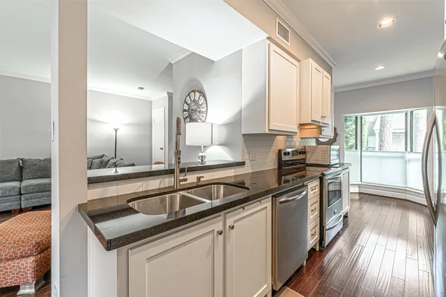 a kitchen that has a sink and a stove
